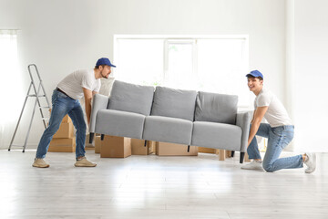 Loaders carrying sofa in room