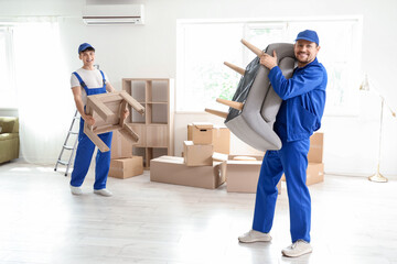Loaders carrying furniture in room