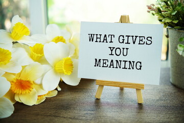 What gives you meaning text message on paper card with wooden easel, Business concept