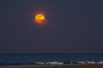 April pink moon rising over the Atlantic Ocean, shot from an Outer Cape Cod beach