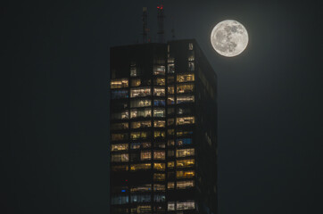 A building and the April pink moon, shot at Boston, the night after full moon night