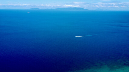 Aerial view of the blue surface of a calm sea. Aerial view of the smooth surface of the sea between...