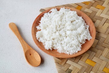cooked white rice on wooden plate