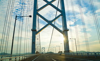 Naklejka premium Drive on the Akashi Kaikyo Bridge, that's the world's longest suspension bridge, and connects Kobe town to Awaji Island.