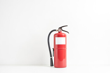 Obraz premium Red Fire Extinguisher on a White Background