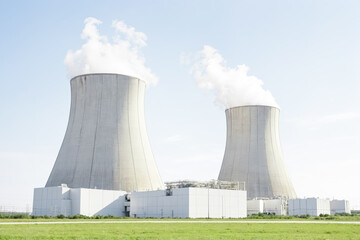 Fototapeta premium Nuclear power plant cooling towers with steam