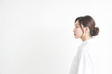 Young woman in a white shirt looking to the side