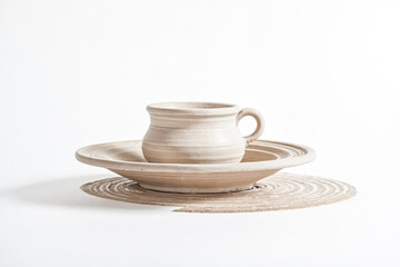 Pottery Cup and Saucer on a White Background