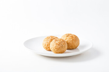 Three Sesame Seed Buns on a White Plate