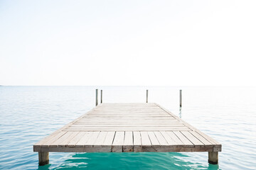 Fototapeta premium Wooden Dock Extending Over Calm Water