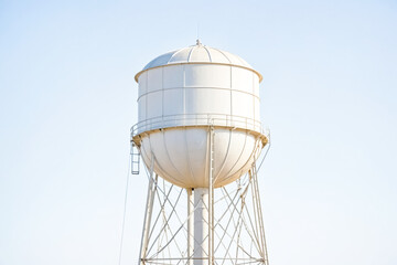 White water tower against a blue sky