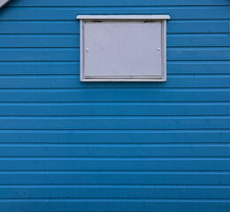 blue plank background with window, beach hut