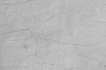 Cracks on the white plaster wall. Abstract design background.