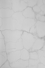 Cracks on the white plaster wall. Abstract design background.