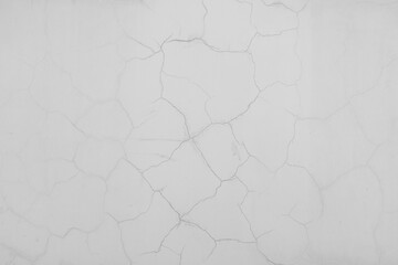Cracks on the white plaster wall. Abstract design background.