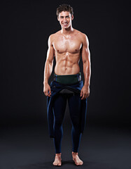 Fototapeta premium Studio background, portrait of surfer or smile for sports, fitness and training for competition event. Professional athlete, male person or model and man with body, muscle or abs with pride