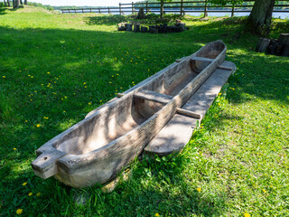 A boat with two balancers carved from a tree trunk. Wooden dugout canoe. A stone age aspen tree...