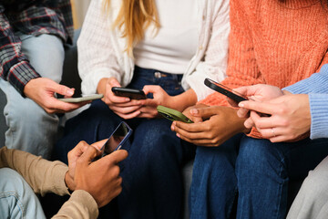 Unrecognizable group of multiethnic friends using the smartphone together.