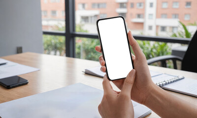 Mockup cellphone Person in office environment showcases smartphone with empty blank screen. Person in cafe hold cell phone, screen blank and white, copy space for text or app display