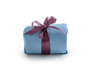 Present wrapped with blue paper with purple ribbon bow isolated on white background