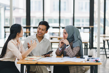 Young diverse people discuss and analyze financial data and marketing strategies, presenting and brainstorming to increase company profits.