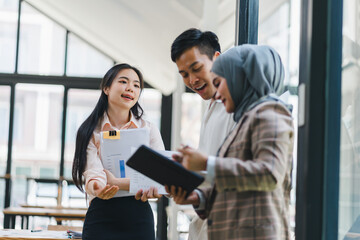 Diverse Team of Financial Advisers Use Digital Tablet to Discuss a Stock Market Strategy in a Modern Company.