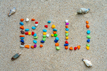 Balinese writing on white sand