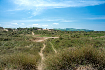 Sand dunes and beach at Talacre a popular tourist destination in North Wales on a bright sunny summer day.
