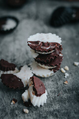 Stack of vegan chocolate cups with caramel on white tabletop. Homemade vegetarian chocolate caramel cups. Ideas and recipes for healthy sweets and dessert. Selective focus. Copy space for text.