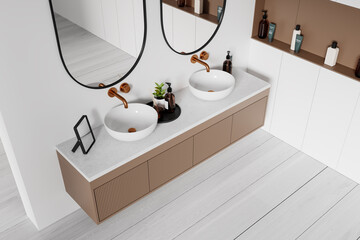 Top view of hotel bathroom interior with double sink and accessories on drawer