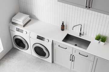 Top view of home laundry interior with washing machines and towels