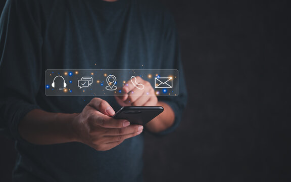 Person using smartphone with communication icons overlay, business marketing online contact us support, and customer service. digital technology help client internet