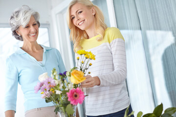 Smile, mom and happy woman with flowers in home together with joy, love and wellness for affection....