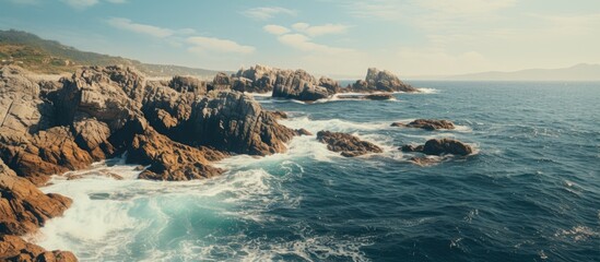 Rocky coast waves blue sky - Powered by Adobe