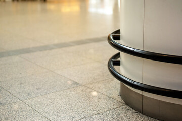 Metal pipes encircle a column, forming a protective barrier
