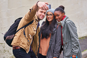 Wall, friends and selfie for picture outdoor before campus, college and university with backpack. Street, academic people and students with happiness, bonding and travel in Canada for photography