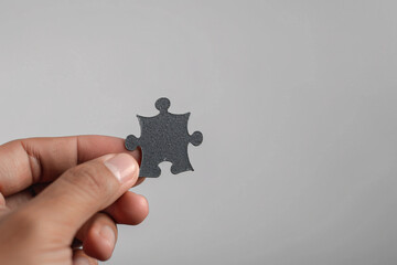 Jigsaw puzzle in hand, isolated on a white background for business.