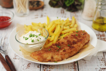 Fish and chips served on the plate, traditional dish of Great Britain	