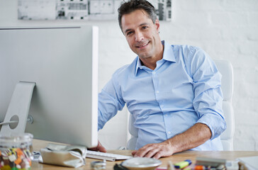 Portrait, entrepreneur and man with smile in office, computer and internet for email, proposal and...