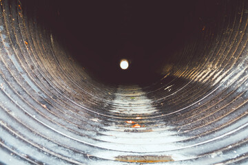 Big culvert under the highway. On the water in the pipe and shoots