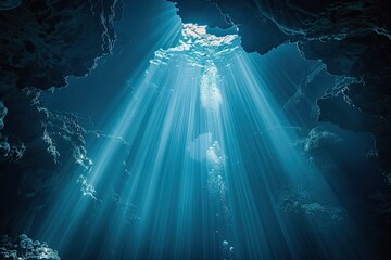 A bright blue sky with sunlight shining through a cave. The light is reflecting off the water and creating a beautiful scene