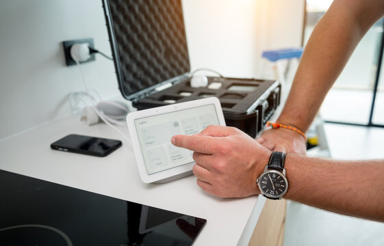 A technician works with a demo kit of the smart home system