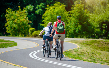 Cyclists ride on the bike path in the city Park
