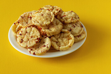 Potato chips with red beets on a yellow background