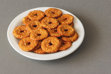 Round crackers with a hole and salt on a gray background