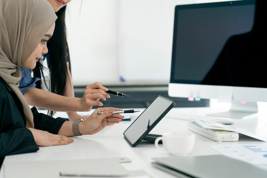 professional business financial analysts or accountant looking at the laptop screen, discussing and planning a project togethe