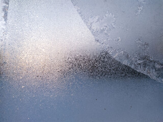 Blue Frost Background, Closeup Frozen Winter Window Pane Coated Shiny Icy Frost Patterns. Natural Ice Pattern on a Frosty Glass