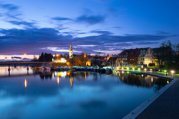 Fototapeta premium 2023-04-28; panorama Mikolajskie Lake of town, marina for yachts and boats at the waterfront. Mikolajki, Poland.