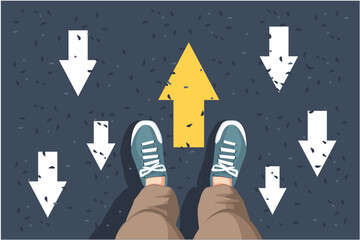 man sneakers on asphalt and opposing direction arrows on asphalt ground, personal perspective footsie concept for finding your own way
