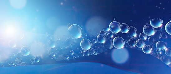 Blue bubbles gracefully floating in a beautiful abstract background with copy space image